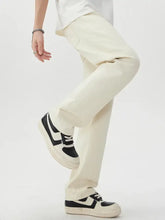 Cream-colored wide leg jeans made of cotton with straight-leg relaxed fit and subtle stitching details