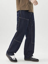 Men’s dark blue denim wide leg jeans with white stitching and multiple patch pockets