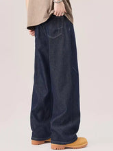 Men’s dark indigo wide leg jeans with relaxed straight cut silhouette and visible stitching details in denim material
