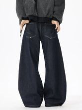 Men’s dark indigo denim wide leg jeans showing the back side with contrasting white stitching on pockets