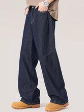 Men’s dark indigo denim wide leg jeans with relaxed fit and visible stitching details