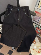 Men’s dark wash wide leg jeans with light blue decorative studs along the waistband and pockets
