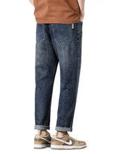 Dark-wash men’s wide leg jeans with relaxed fit and rolled cuffs designed for comfort and style