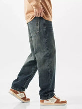 Men’s wide leg jeans in dark-wash denim with a relaxed straight-leg cut and classic stitching details