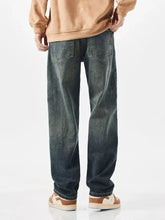 Men’s wide leg jeans in dark-wash denim with a relaxed straight-leg cut and faded detailing