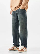 Men’s wide leg dark-wash denim jeans with a relaxed straight-leg cut and subtle fading for a casual worn-in look