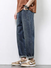 Men’s dark-wash denim wide leg jeans with a relaxed straight-leg cut and rolled cuffs for casual wear