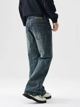 Men’s wide leg dark-wash denim jeans with a relaxed straight-leg cut and subtle fading
