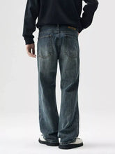 Men’s wide leg jeans shown from the back in dark-wash denim with a relaxed straight-leg cut and classic pockets