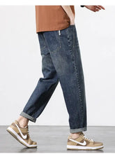 Men’s dark-wash denim wide leg jeans with relaxed straight-leg cut and rolled cuffs