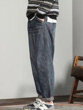 Men’s wide leg dark-wash denim jeans with a relaxed tapered fit and rolled cuffs for casual wear