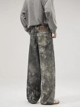 Men’s wide-leg jeans in distressed gray and white marbled denim with a wide leg design