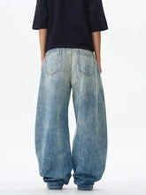 Men wide leg jeans in faded blue denim with a relaxed oversized fit featuring wide leg design for comfort and style