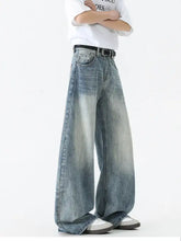 Men’s wide leg jeans in faded blue denim with subtle whiskering details for a stylish casual look