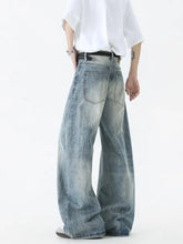 Men’s wide leg jeans in faded blue denim with classic stitching and a relaxed fit for casual wear