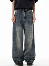 Men’s wide leg jeans in faded denim with distressed and whiskering details for casual wear