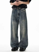 Men’s wide leg jeans in faded distressed denim with subtle fading along the legs for a stylish casual look
