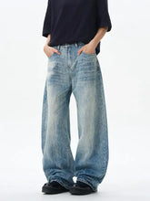 Men wide leg jeans in faded light blue denim with subtle distressing and a relaxed loose fit