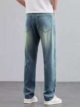 Men’s wide leg light-wash denim jeans with a faded gradient from dark blue waist to lighter hem