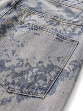 Men’s wide leg jeans in light-wash denim with a faded blue and gray tie-dye pattern