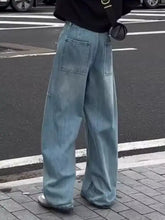 Men’s light-wash denim wide-leg jeans with a relaxed straight-cut silhouette and prominent front pockets