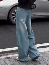 Men’s light-wash denim wide leg jeans with a relaxed baggy fit and visible stitching details in a wide-leg cut