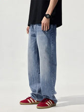 Men’s wide leg jeans in light-wash denim with relaxed fit and subtle fading for casual wear