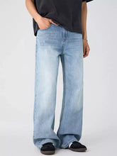 Men’s light-wash denim wide leg jeans with a relaxed fit showcasing comfortable wide leg design