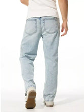 Men’s wide leg jeans in light-wash denim with relaxed fit and classic back pockets shown from the back side