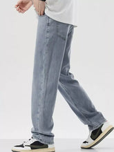 Men’s wide leg jeans in light-wash denim with a relaxed straight leg cut and classic stitching details
