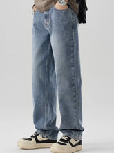Men’s wide leg jeans in light-wash denim with a relaxed straight-leg cut and subtle fading for a casual modern look