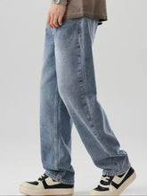 Men’s wide leg jeans in light-wash denim with a relaxed straight-leg cut and subtle fading for a casual modern look