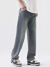 Light-wash denim jeans with a relaxed, straight-leg cut and subtle fading along the thighs.