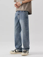 Men’s wide leg jeans in light-wash denim with a relaxed straight-leg cut and subtle fading for a modern casual look