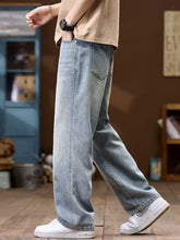 Men’s wide leg jeans in light-wash denim with a relaxed straight-leg cut and classic stitching details