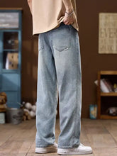 Men’s wide leg jeans in light-wash denim with a relaxed straight-leg cut and classic stitching details