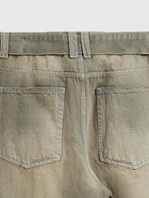 Men’s wide leg jeans in olive green distressed denim with frayed pocket edges and a faded worn in look back view