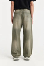 Men’s wide leg olive green denim jeans with faded distressed finish and classic back pockets shown from the back side