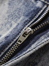 Men’s wide leg jeans with silver ykk zipper featuring metallic teeth and pull tab on dark blue denim fabric