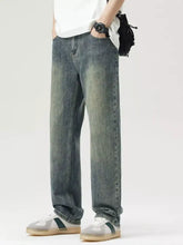 Men’s wide leg jeans in washed denim with a relaxed fit and faded blue wash for casual wear