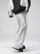 Men’s wide leg white denim jeans paired with a black and white jacket showcasing casual modern style