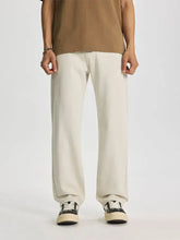 Men’s wide leg jeans in cream cotton with a relaxed fit and straight leg design shown from the front