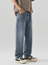 Men’s wide leg light-wash denim jeans with a relaxed straight-leg cut and subtle fading for a casual modern look