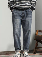Men’s wide leg jeans in blue denim with a relaxed fit and rolled cuffs showcasing casual style