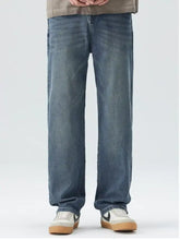 Men’s wide leg blue denim jeans with straight-leg cut subtle fading and functional pockets visible from the front