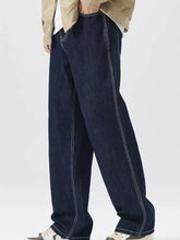 Men’s dark blue denim wide leg jeans with white stitching and pockets for casual wear