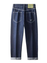 Men’s dark indigo wide leg jeans with white stitching, rolled cuffs, pockets, and a patterned waistband label