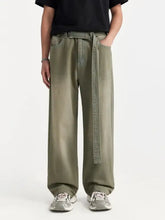 Olive green wide leg denim pants for men with matching belt looped through the waistband in front view