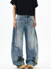 Men’s wide leg denim jeans in faded blue wash with yellow paint splatter accents for casual wear