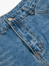 Mens wide leg relaxed fit denim shorts in light blue with distressed button zipper design